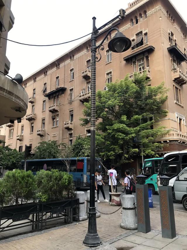 Lampposts between the pedestrian section and the second part of the street.